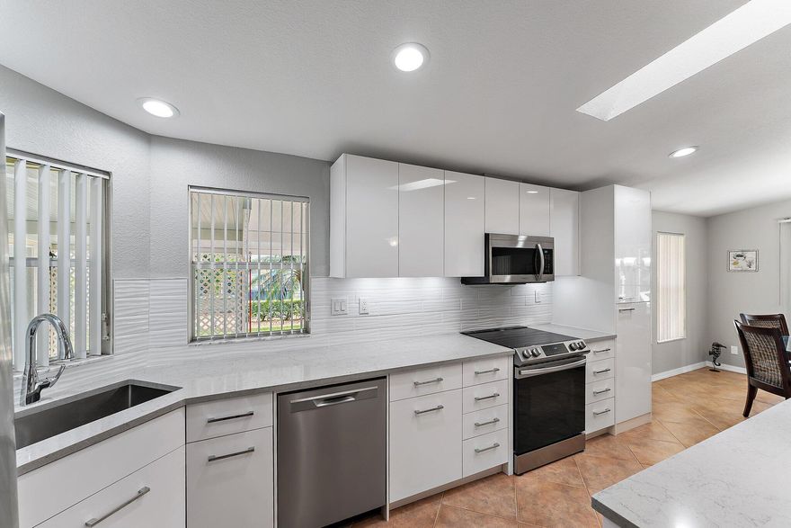 Welcome to Florida retirement in this beautiful Islander III model with Garage and carport!. Home is fully furnished and features 2 BR's, 2 BA's, and an additional den/office, or 3rd BR w/ French doors. The heart of the home is updated with a modern styled kitchen, adorned with quartz countertops and SS appliances. Primary bath has updated cabinetry, countertops, dual sinks and additional storage. Home has a 2020 roof and a 2-car gar. along with an oversized covered carport, cost saver irrigation well with updated  hurricane anchors.  Step out and unwind on the 27'' screened lanai or enjoy the outdoor patio with lake views. This home has it all and located in the amenity packed 55+ Savanna Club community. Land Lease Property. All measurements approximate, buyer to verify