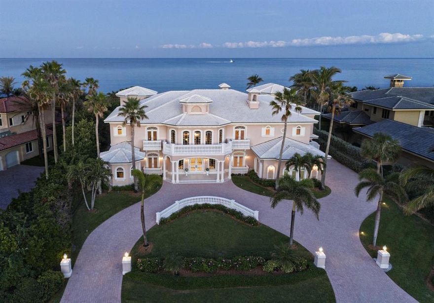 Oceanfront living on a grand scale in this spectacular seaside manor.  Formal living area welcomes guests with its oceanfront views.  Adjoining dining room includes butler's pantry & custom wine room.  Gourmet kitchen & adjoining family area offer extensive room for entertaining & casual living.  Kitchen features custom cabinetry, granite countertops & massive center island with abundant storage. The home's private quarters exude quiet opulence, with uniquely situated en-suite baths and imported Versace tile throughout. Outdoor spaces feature heated swimming pool & spa, private dune walk to beach & summer kitchen set within a gazebo.