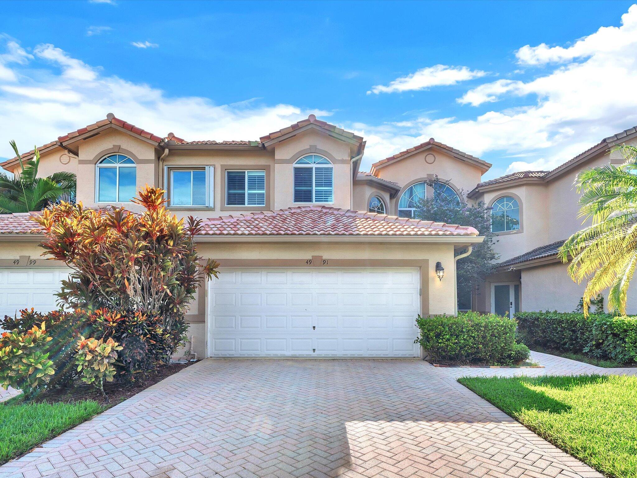 Beautiful oversized 3BD/3.5BA townhouse with a 2-car garage, vaulted ceilings, and impact windows throughout. The spacious kitchen boasts granite countertops, stainless steel appliances, ample cabinet space and a cozy breakfast area. The first-floor master suite features a walk-in closet and French doors leading to a large screened patio with sun-blocking shades. 2nd floor offers two bedrooms, including one with plantation shutters, plus a spacious loft. Laundry room includes a new washer and dryer. Roof: 4 years old, A/C: 5years old. This home is truly move-in ready don't miss your chance to own this exceptional property!