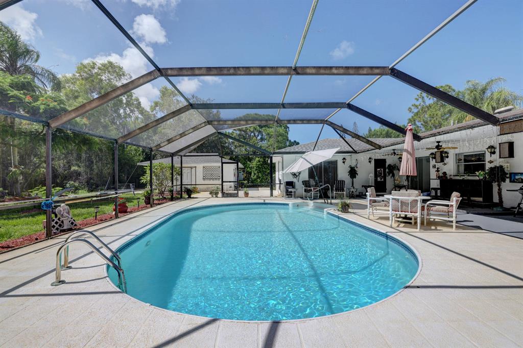 WOW - FIRST TIME TO MARKET! Exceptional 4 Bedroom | 3 Bathroom with .39 Acres POOL Home. Three Car Garage ( 2 car attached and 1 car detached) as well as seperate GUEST Quarters! Entertainers Dream with this large home with formal living and dining area as well as family room with open concept to kicthen. This Home has 3 AC Systems - 5 years old. Roof is 5 years old. LOCATION LOCATION! This home is close to downtown Stuart, Beaches, Major Roadways!