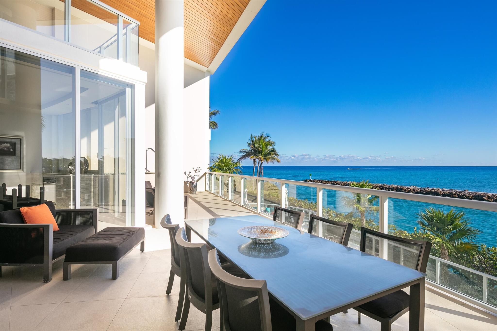 Set within the prestigious One Thousand Ocean, Beach Villa 103 is a true generational offering--an irreplaceable, two-level condominium whose rarity and distinction place it in a class of its own, unmatched both within the building and along the entirety of Boca Raton's oceanfront. As you step inside, you're greeted by dramatic ceiling heights and an infusion of natural light that flows effortlessly throughout the home, accentuating its sleek, modern aesthetic and amplifying the spacious ambiance. Thoughtfully designed with a seamless, open-concept layout and desirable southeast oceanfront orientation, this singular property captures expansive, tranquil views of the Boca Raton inlet and the Atlantic Ocean, offering a daily display of natural beauty that defines elevated coastal living.