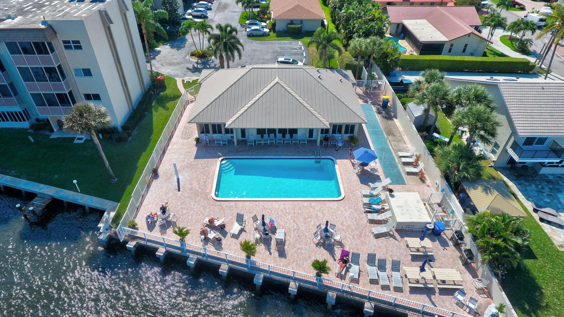 Direct Waterfront Community located on the Intra Coastal. Snug Harbor Gardens is a hidden gem. Not only are the views and water life entertaining as you relax by the heated pool, but the location is close to pretty much everything, a short distant away. Beautiful South Florida beaches, parks, PBI, train station, grocery store, pharmacy, banks, restaurants and 15 minutes from Delray Beach and so much more. The community also hosts great events for you to join in on. This 2 bedroom 2 bath needs your personal touches but newer AC and primary bath w/shower. Screened in lanai too! Clubhouse with large kitchen and dining room, library/card room, fitness room with lovely ICW views. New sea wall being installed now. Come see what all the fuss is about! I live here I love it!