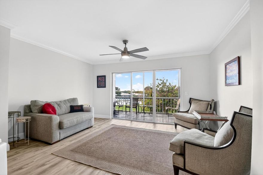 MOTIVATED SELLER! Amazing Lake & Golf Views from this Open & Spacious 2 Bedroom 2 Bath Condo w Bonus Room. Completely Renovated & Move-in Ready! Enjoy the tropical breezes & beautiful lake views from the patio. Chefs Kitchen has expanded counterspace, newer appliances & extra pantry space. Entertain in the two living areas beyond the dining room. Large primary suite opens to the lanai. Covered & assigned parking spot with extra guest spots. Building completed 40 yr inspection; NEW roof, balconies, paint and carports! Located in the City of Atlantis, a 24/7 gated country club community, with two championship golf courses without mandatory membership. Access to Kintz Park with tennis, pickleball, a water park, and community spaces. Close to beaches, I-95, and major airports. MOVE-IN READY!