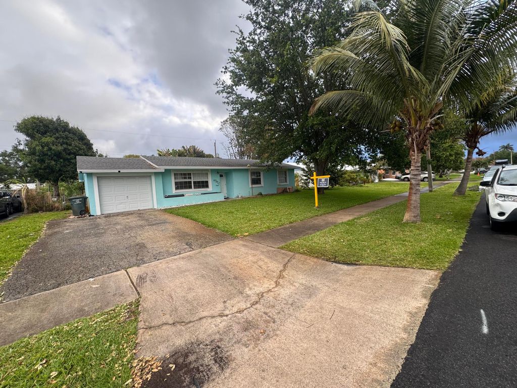 Photo of 521 E Redwood Drive, Lake Park, FL 33403 (MLS # B26011775)