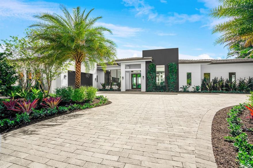 Modern designed waterfront masterpiece by Sam Fisch Development in gated community, Land Of the Presidents. Bright and open concept offers 6000 sq feet of waterviews from every room. Soaring 15 foot ceilings and polished concrete and wood floors make this unique custom home shine. Offering 5 bedrooms and 5 1/2 baths make this perfect home for indoor and outdoor living alike. Large outdoor kitchen and patio balance the huge open land unlike any property in West Palm Beach. Top of the line finishes including Sub Zero and Wolf appliances, quartz countertops and oak floors in all bedrooms. Enjoy waterfront living at its finest in this exclusive gated enclave.