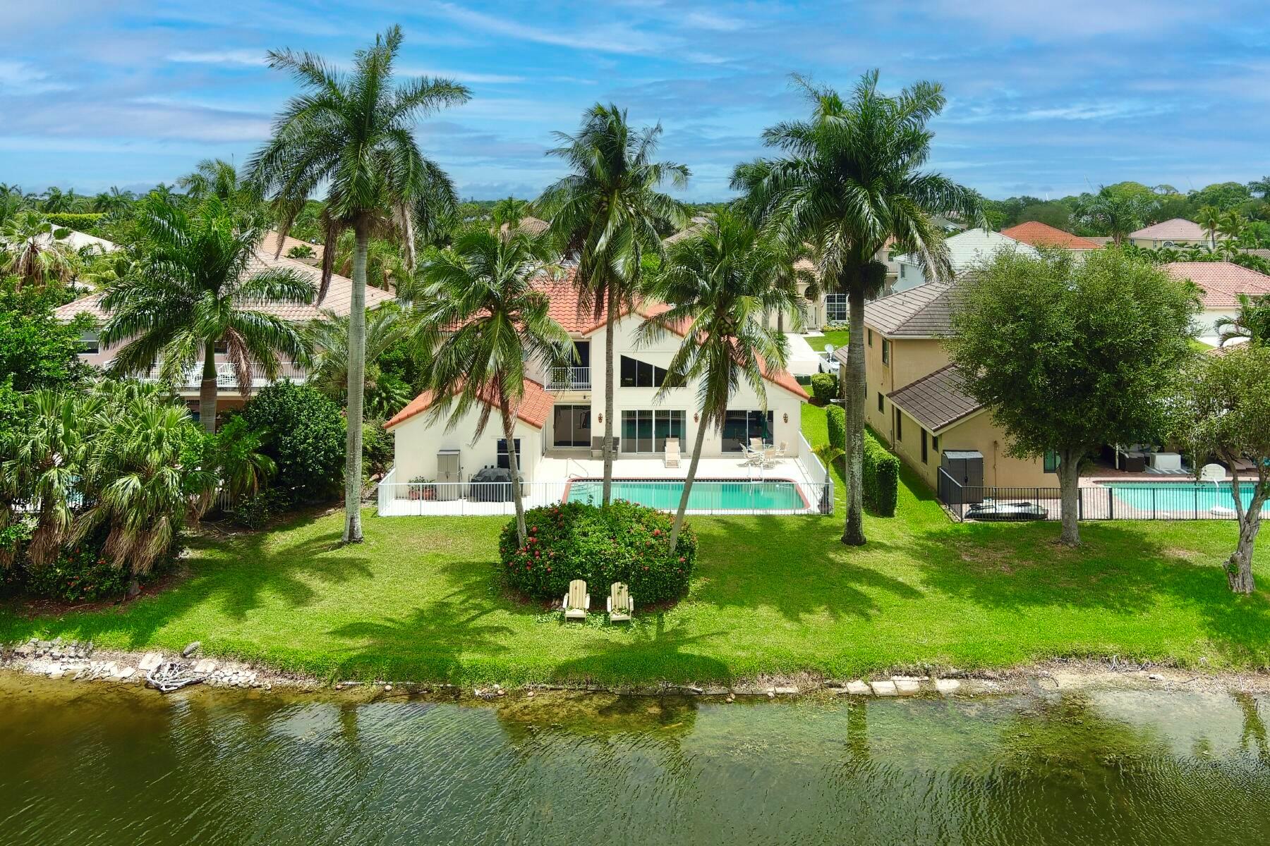 Welcome home to your stunning lakefront estate located in the highly coveted Le Paiais section of Rainbow Lakes. This 4BR, 3BA home has been beautifully updated and boasts gorgeous waterfront views--enjoy the breathtaking sunsets over the lake from your private backyard oasis. The home's primary suite is located on the first floor and offers two large walk-in closets and a spa-like bathroom complete with new dual vanities, a soaking tub, separate shower, and water closet. The oversized, open, eat-in chef's kitchen boasts copious amounts of storage in the custom wood cabinets, granite countertops and backsplash, a spacious pantry, a large island with new cooktop, and stainless steel appliances. The first floor enjoys new designer wood-like tile throughout, high ceilings, a cabana bath,
