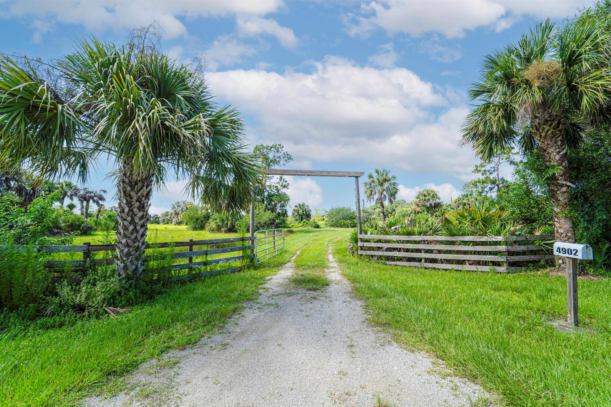 Luxury, privacy & the freedom of land! The best parcel in Stuart Woods Ranch is now available for purchase. 20 Plus Acres of serenity that feels like you're in the country yet less than 15 minutes from Palm City. Land your helicopter on the raised pad then ride your off road vehicles around the one acre pond. There is a leveled airstrip with windsock for flying your high end model planes or even landing a STOL aircraft. Scattered around the fenced & gated land are mature Oaks, Saw Palmettos & Sabal Palms covered with Spanish moss. A house pad ready to build on along with a plumbed hunters cabin, underground electric & well. This is a peaceful neighborhood with low HOA & friendly neighbors. The value of land in western Martin County continues to rise, secure your piece of paradise today.