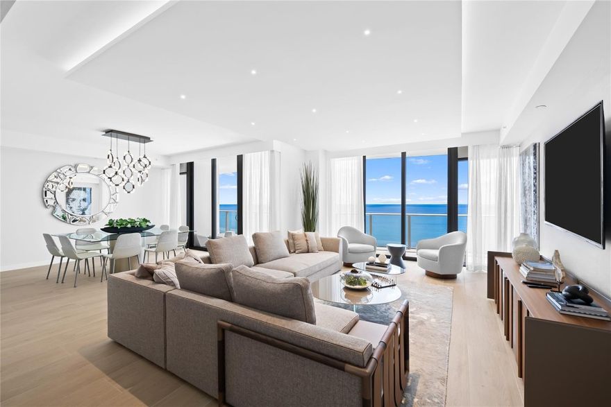 Experience unparalleled oceanfront living directly on the sand in this stunning 4BR/4.5BA residence. This expansive double unit spans over 4,000 SF, showcasing a contemporary open floor plan and a Chef's kitchen designed for both entertaining and everyday living. Walls of floor-to-ceiling glass capture sweeping views of the Atlantic Ocean and ICW, with balconies on both sides for showcasing daily sunrise and sunsets. Two entries provide the utmost privacy and convenience. Resort style amenities include oceanfront pool 1,300 SF of terraced green space, state-of-the-art fitness center, theatre room and an elegant wine room. Perfect as a full time residence or vacation retreat.