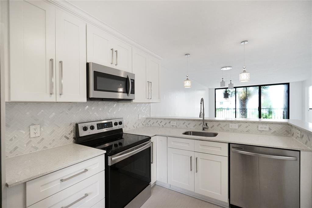 **NO ASSESSMENTS** Welcome to The Fountains of Palm Beach a beautifully maintained 55+ Gated Community offering comfort, convenience, & resort-style living! This fully renovated 2B/2B condo features a bright, open layout with serene water views from the screened-in balcony. Enjoy modern upgrades throughout, including a stylish kitchen with white cabinetry, quartz countertops, S/S appliances, & a convenient **IN-UNIT WASHER & DRYER**. Additional highlights include new laminate flooring, freshly painted interiors, updated bathrooms, & walk-in closets. Extra storage space is also included. Enjoy resort-style amenities: clubhouse, pool, tennis, fitness room, 24/7 security & more. Unit comes with 1 Assigned Parking Space + ample guest parking. Close to dining, shopping & highways. See it today!