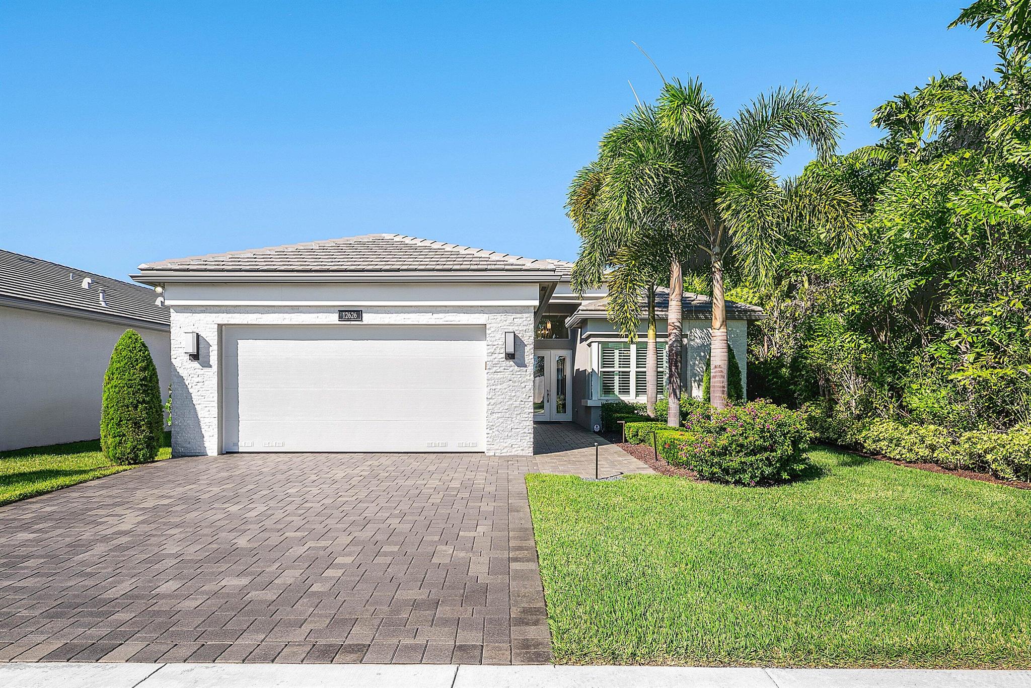 Situated in the distinguished 55+ gated community of Valencia Sound in Boynton Beach, this Aruba model comes with DESIGNER FURNITURE INCLUDED! (Serena and Lily, RH, Ballard Design, Arhaus, Frontgate) The home offers 2 bedrooms plus a den, 2 full baths, with professional designed upscale interior and exterior finishes. It includes a whole-house generator, designer Serene & Lily light fixtures, retractable blinds with Phantom screens, decorative accent woodwork walls, and a summer kitchen overlooking a long lake view. The home is also built with impact windows for added safety and durability.