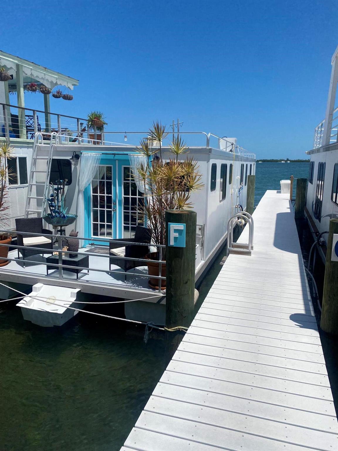 Welcome to your private oasis in the heart of Key West, where the quintessential houseboat dream becomes your reality. Nestled in Key West's most coveted location, hidden, yet central, this 2018 Catamaran Cruiser Houseboat offers you the best of both worlds--serene waterfront living with all your aquatic-activities right outside your door, and just 7-minutes from the vibrant dining and entertainment of Duval Street.With 800+/- square feet of beautifully crafted main-deck space, every inch of this houseboat has been thoughtfully designed by a master carpenter, blending custom craftsmanship with the comforts of home. Above, find a rooftop deck, where 700 square feet of potential outdoor living space await your personal touch.