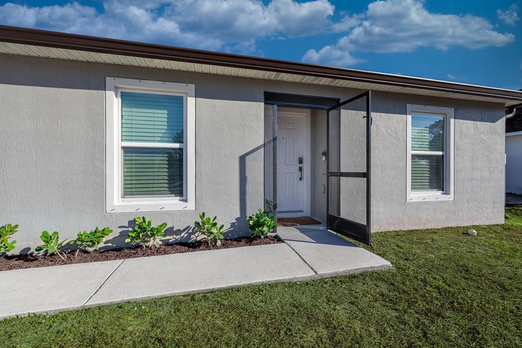 Photo of 1427 SW Leisure Lane, Port Saint Lucie, FL 34953 (MLS # R11152501)