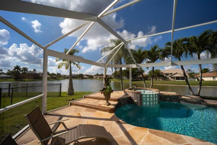 ''Welcome to your Paradise Dream Home! This Boca Winds property has an Enclosed Heated Spa Pool with Jacuzzi. The home sits on a 2911 sqft Lakefront Lot with Amazing Panoramic Lake Views and Breathtaking Sunsets. Located at the end of private Cul De Sac that won't disappoint anyone. This is the BEST LOCATION in the community. Single-story home with 4 bedrooms and 3 full bathrooms. Fully Updated Kitchen and Appliances with Quartz Countertops. Roof (2013), 5 Ton A/C 2018, Crema Marfil Flooring throughout the main areas of the house, Master Bedroom and Bathroom redone with Plank Style Flooring, Laminate Flooring in Bedrooms. NO CARPET, and a Fully Enclosed-Hurricane Proof Sun Room as A BONUS. Community has also Pool and a Beautiful Club House! A+ Rated Schools. Come See and Start Packing!!
