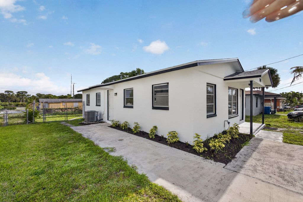 Photo of 1440 Ac Evans Street, Riviera Beach, FL 33404 (MLS # B26018455)