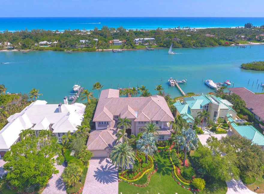 Magnificent 'House on a Hill'... Enjoy Ocean breezes and turquoise Deep water from this palatial Estate in picturesque Indian Hills.   A boater's paradise, this home is located desirably close to the Jupiter Inlet for easy Ocean access.  Design elements offer a perfect combination of elegance and comfort - perfect for grand entertaining inside and out.  Impact windows/doors, linear diffuser A/C.  Interior features marble floors and craftsman finishes throughout. Living area leads to family room & chef's kitchen complete with wet bar, dual refrigerators & custom wine fridge.   Master BR offers serene luxury, oversized closets (w/ large safe) & glamorous master bath.  Elevator/grand staircase lead to spectacular second floor.   Outdoor Boaters room by dock w/ freezer, storage+work station!