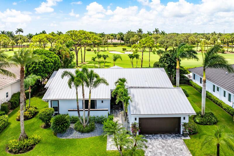 Imagine a stunning house situated on a picturesque golf course, designed with an open floor plan that seamlessly blends indoor and outdoor living. Enjoy alfresco dining on the patio, take a dip in the pool, or practice your swing with direct access to the golf course. The house boasts a clean, contemporary design with a combination of stucco and wood accents. A metal roof and geometric lines enhance its modern appeal.Elegance and position of this exquisite home has added bonus - one of the kind membership structures, 27-hole championship golf course with no teatime, 8 Har-Tru tennis and 4 pickle ball courts, resort style pool, state of the art fitness center, 324 stunning custom homes, magnificent lifestyle and rare sense of community.