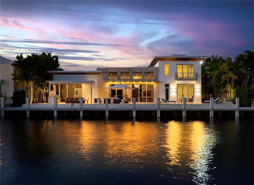 Waterfront luxury and elegance abound at this modern Coral Ridge residence with unrestricted ocean access. Turnkey, Smart Home, 5 bedrooms and 5.5 baths including 2 primary suites with water views, a great room with saltwater aquarium, Wolf appliances, electric shades. The residence is equipped with solar panels and 2 Tesla Lithium batteries for clean power, 2 electric car chargers, garage to fit a lift for 2 additional cars. Inviting backyard, brand new concrete 100ft dock to accommodate ±80ft yacht, infinity edge heated pool and spa with firepit, cabana with grill. Unmatched location close to the beach, shopping, restaurants, Coral Ridge Country Club, great public and private schools in proximity.
