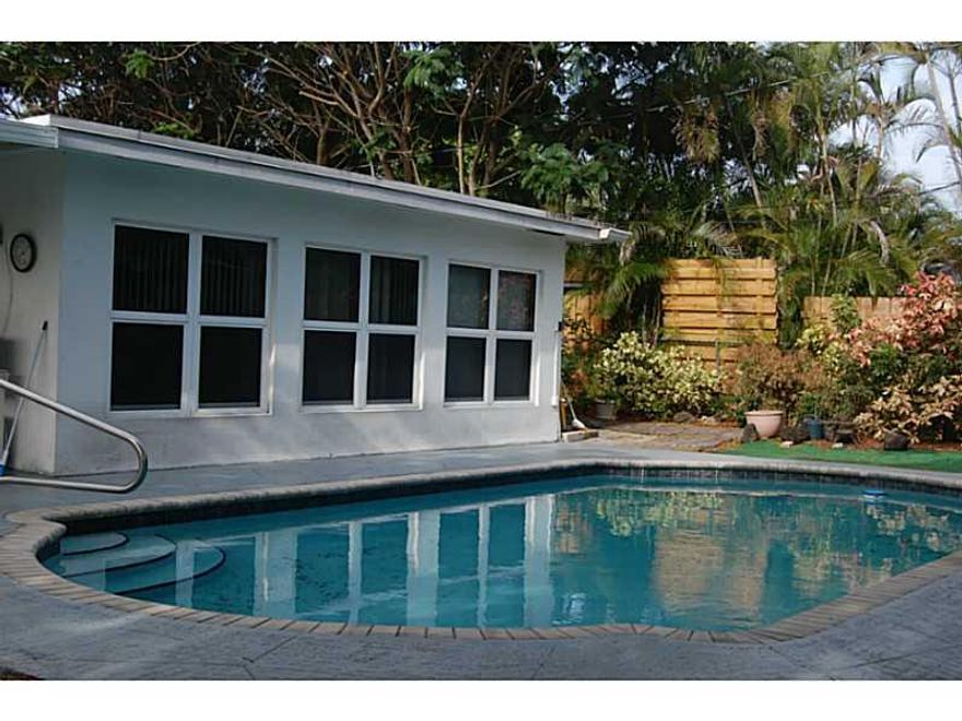 OWNER MOTIVATED! PRICE REDUCED! Beautiful 2/2 in Imperial Point. NEW UPDATED ELECTRICAL PANELS inside & out. NEW WATER HEATER.  HOME WARRANTY provided. HURRICANE Impact Windows and Doors. Nicely updated home with tile floors throughout. Large Den with sli ding doors leading to Florida Room with view of pool. Large fenced in tropical back yard for privacy,pets.  Open style kitchen with laundry room adjacent.  Garage has been converted into a bonus room.  Easy access to  US1, shopping, I-95, Beaches, Pavers.