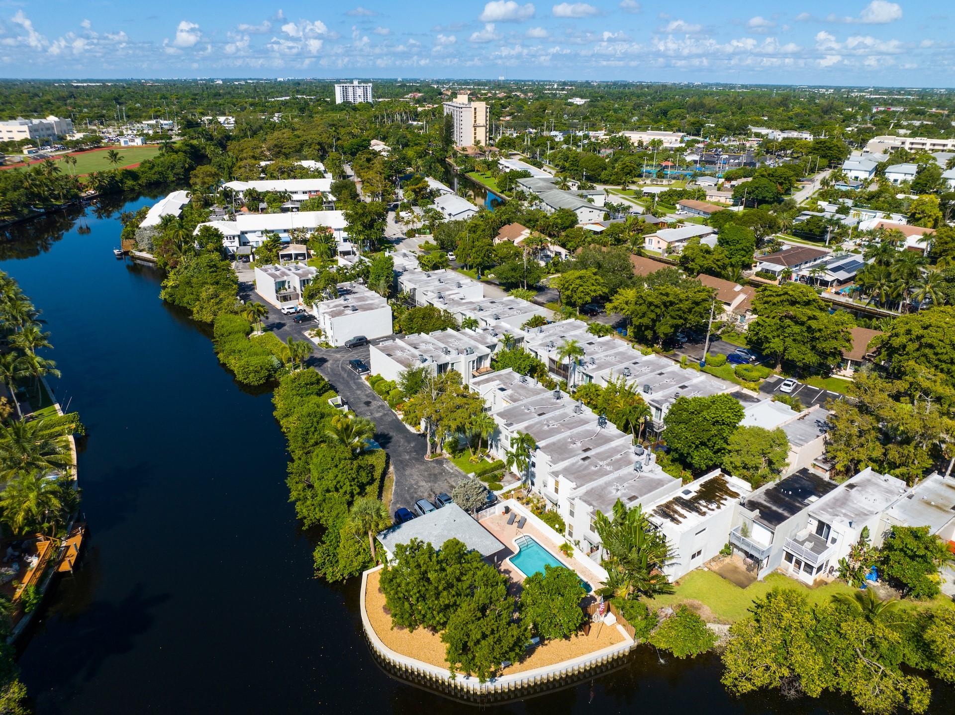 One of Wilton Manors best kept secrets. Townhouse Isle is just steps from Wilton Drive .This hidden enclave of town homes with mature trees lining the streets is a magical spot. Surrounded by tranquil water that invites you to kayak , paddle board, or relax by the pool . This 2 bedroom 2.5 bath town house has 2 spacious ensuite bedrooms . The primary bedroom offers a peek a boo water view off the balcony. There is a fabulous back patio. This unit boasts updated kitchen and bathrooms , Impact windows and doors , neutral tile and gorgeous wood look floors upstairs. The finishes are exquisite. Pristine move in ready condition. Minutes to Ft Lauderdale's famous beaches, steps to the restaurants and entertainment of the Drive yet secluded A TRUE GEM
