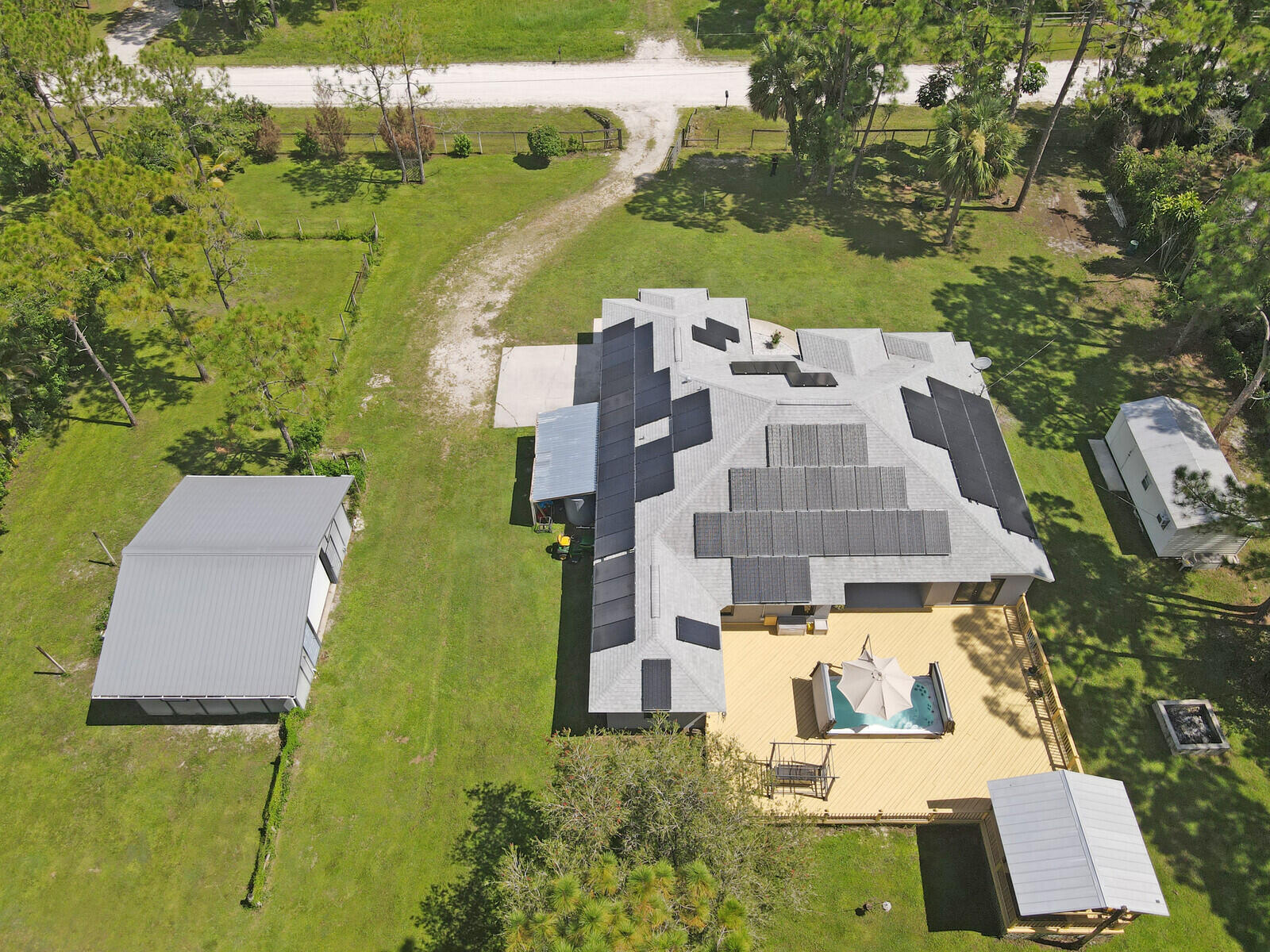 Enjoy wide-open spaces, privacy, and the freedom of living without an HOA in this well-maintained Loxahatchee property. Set on 1.15 acres, this home is more than just a place to live--it's a lifestyle. Whether you're seeking space to grow, room for hobbies or a home-based business, or simply a peaceful escape, this versatile property offers endless possibilities.Inside, the home features a thoughtfully designed split floor plan with four bedrooms and three bathrooms, all enhanced by luxury vinyl plank flooring that runs throughout. The insulated, impact-rated, and tinted windows allow natural light to flood the interior while providing storm protection and energy efficiency. Every opening is protected, with impact-rated windows and sliders throughout the home, while the French door