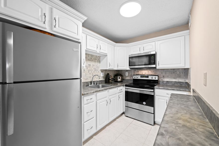 Bright & Airy 2/2 condo located at Sabal Palm Village in Tamarac, 55+ Community. This cozy unit is located on the 2nd floor - Features updated large white kitchen with SS appliances, NEW vinyl flooring throughout & NEW Roof! Large master bedroom with walk-in closet and combo tub/shower. Guest bedroom has mirrored closet - Being used as an office. Spacious screened patio with wroll-ups - Can be used as a Den/ Storage. Laundry room on premises located on same floor, unit comes with extra storage room. The association offers a clubhouse with library, fitness room, heated pool, BBQ area & tennis courts. Secured Lobby. Priced to sell! No minimum income required! Mins to Turnpike, Shopping Plazas & Restaurants. Great Primary or Seasonal residence. Priced to Sell! Schedule your viewing today!