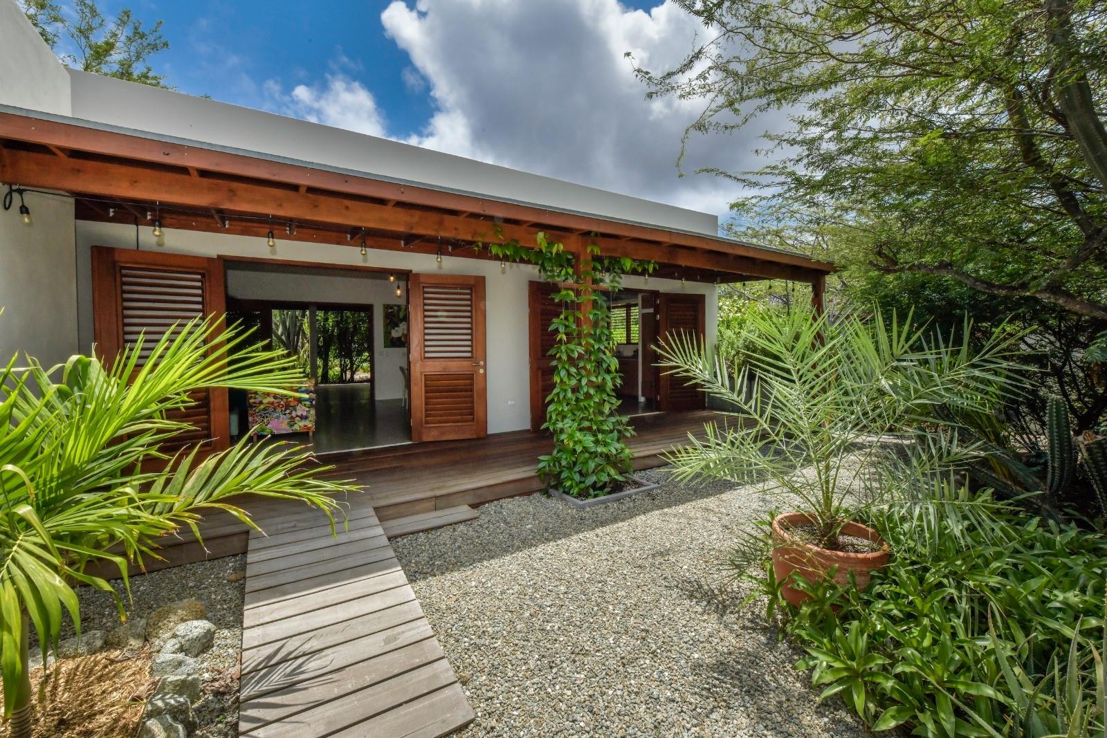Nature-Infused Retreat with Income-Generating Airbnb Apartments in Picaron, Santa Cruz, ARUBA
Welcome to your private oasis in the heart of Santa Cruz, this charming retreat property offers the perfect blend of tranquility, nature, and investment potential. Set on 16967 Sq ft of full-ownership land, the property features a spacious main residence along with two fully equipped private apartments currently listed on Airbnb—ideal for generating passive income or hosting guests. A refreshing swimming pool sits at the front of the yard, easily accessible from all living spaces and perfect for unwinding or entertaining.
Surrounded by lush greenery and infused with a sense of calm, this property is ideal for use as a private retreat, a wellness-focused escape, or a boutique vacation rental.