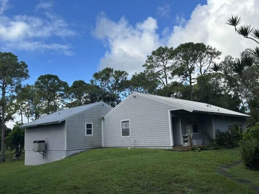 Come make this home yours!! 3 bedroom, 3 full bathrooms, large family room, galley kitchen and huge primary bedroom added to back for your own oasis. Very private, serene, newer metal roof installed 2021, main AC unit new in 2023. Sitting on approx. 1.31 acres tucked behind mature trees at very end of street. There is an awesome mancave and a pond with a walking bridge over it. Gas stove, and whole house generator.  A canal borders the east side.  All room sizes are approximate. Please do your own due diligence. This property is finalized from probate. Current owner has no knowledge of any issues with property. Home is being sold AS-IS with the right to inspect.