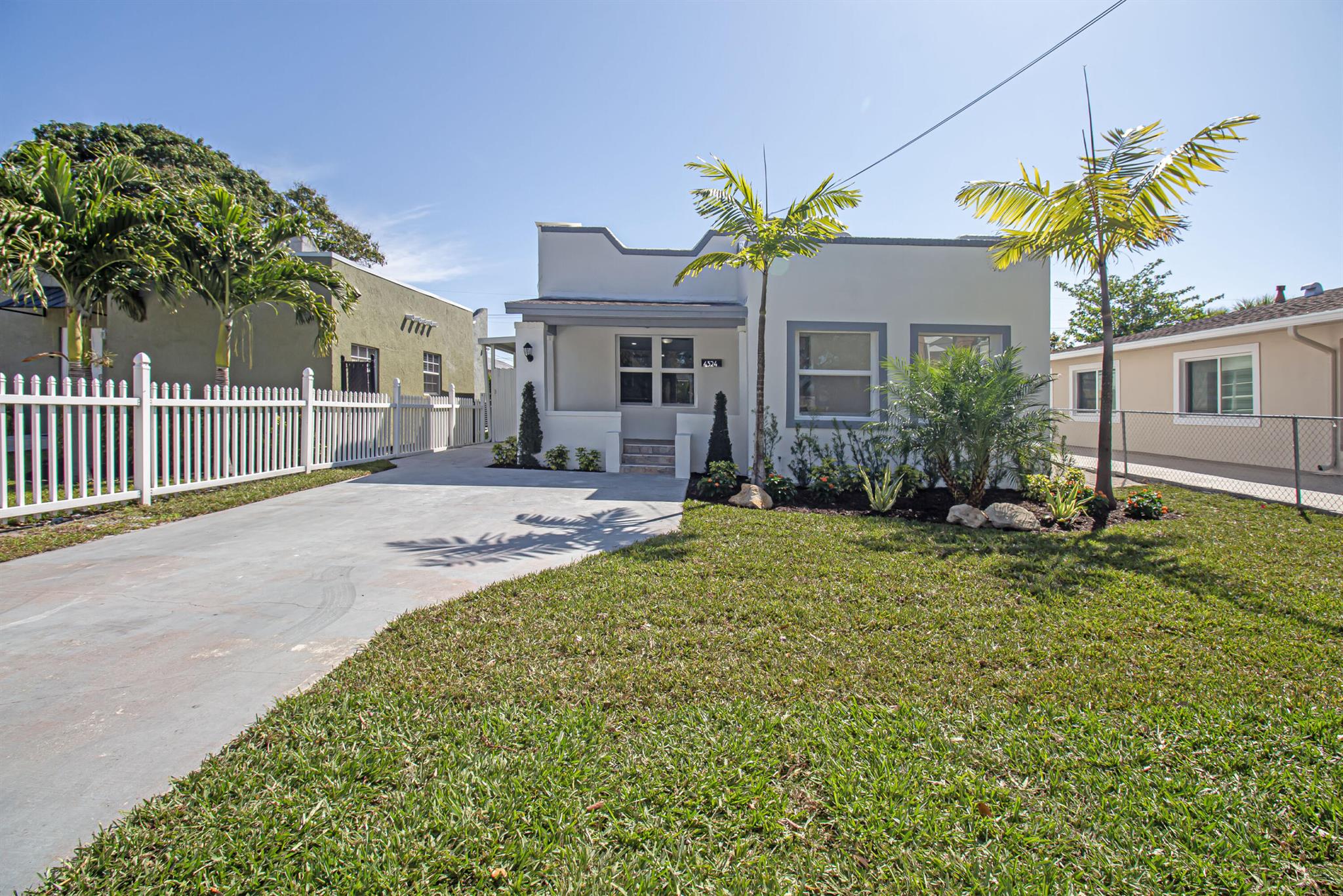 Welcome to this beautifully restored Mediterranean Revival home located in one of West Palm Beach's most desirable neighborhoods. This residence effortlessly blends timeless architectural charm with modern updates designed for comfort and functionality. With four spacious bedrooms and two elegantly remodeled bathrooms, this property offers an ideal layout for both everyday living and entertaining. Inside, you'll find porcelain tile flooring flowing seamlessly throughout the home, complementing the custom wood cabinetry, quartz countertops, and premium stainless steel Samsung appliances in the kitchen. The open concept design provides a bright and inviting atmosphere, while select impact windows, central A/C, and ceiling fans in every room enhance comfort and energy efficiency year roun