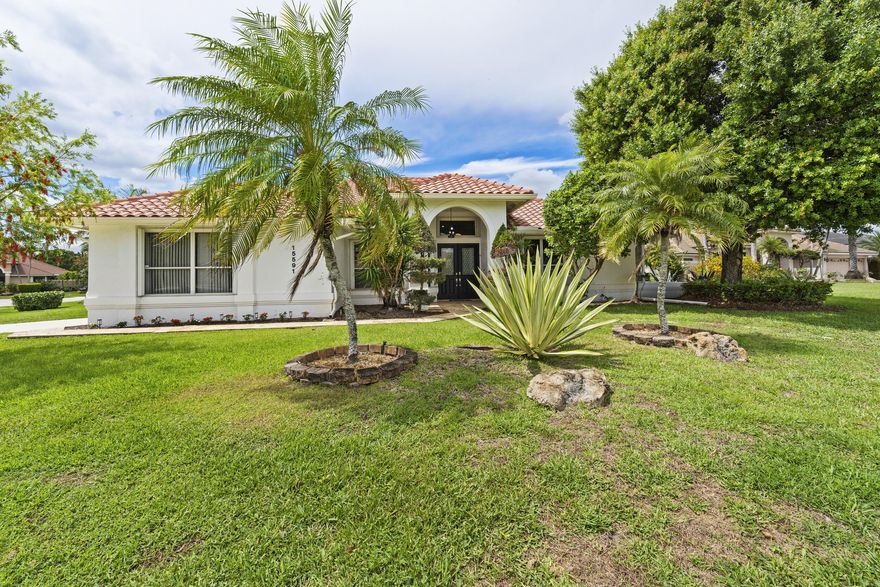 Welcome to your private retreat in the heart of Wellington! This beautifully maintained single family home is ideally situated in a spacious corner lot within a quiet cul-de-sac in a prestigious gated community surrounded by a golf course. Featuring 3 bedrooms plus a versatile den complete with a closet and easily used as a 4th bedroom. This home offers flexibility for families, guests, or a home office. Vaulted ceilings and 4 sets of French doors fill the home natural light and add timeless charm throughout. Designed for both comfort and peace of mind, the property includes full hurricane protection, a convenient side load garage and classic plantation shutters. Step outside to your own tropical oasis: a stunning screened enclosed pool area with an oversized covered lanai, perfect for  entertaining or relaxing year round, The lush, mature landscaping creates a private backyard setting. This is Florida living at its finest. Combining space, style and serenity in one exceptional home. Recent enhancements include  New HVAC, New Hot Water Heater, New Pool Pump, New Sprinkler Pump, Newer Kitchen Appliances, Roof 2015. Located in the heart of Wellington, with easy access to the Florida Turnpike and I-95, Lakefield West is within minutes of The Wanderers Club, Palm Beach International Equestrian Center, International Polo Club Palm Beach, Wellington National Golf Club, and A-rated schools just to name a few!