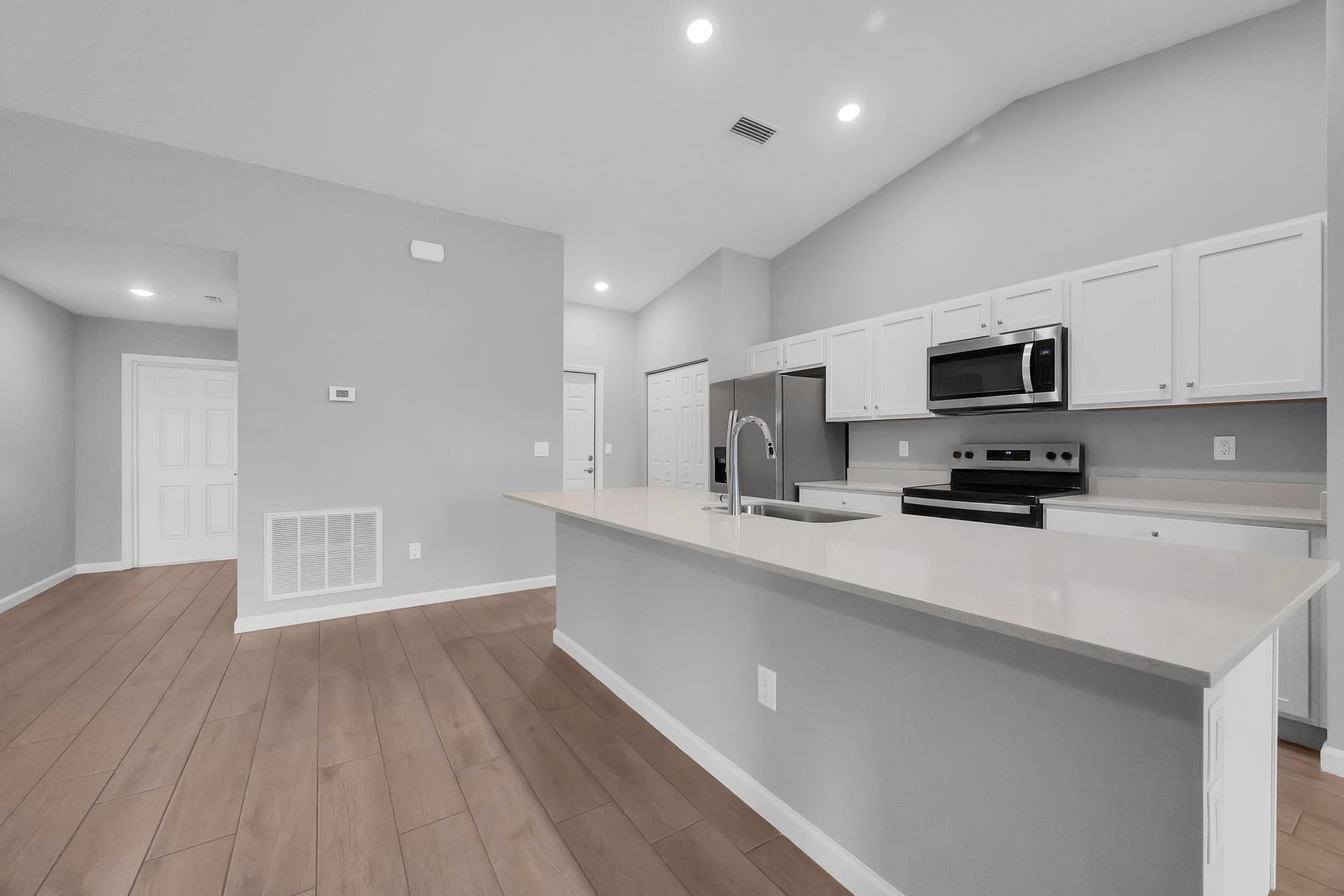 Welcome to this stunning newly built 4-bed, 3-bath, 2-car garage home in a prime Port Saint Lucie location with NO HOA! Be the first to live in this beautiful BRAND NEW HOME with over 2,000 sq ft of living space and a 2-car garage. Located in a quiet area just 5 minutes from Tradition with NO HOA and easy access to I-95 and main roads. Features include WOOD-LOOK TILE flooring THROUGHOUT, quartz countertops, volume ceilings, and an open-concept layout perfect for entertaining. The spacious kitchen, split floor plan, and modern finishes make this home ideal for families or multi-generational living. Enjoy quality, privacy, and convenience in one of Port Saint Lucie's most desirable locations with A rated schools. No HOA. Brand New. Exceptional Location. Application required. Available NOW!