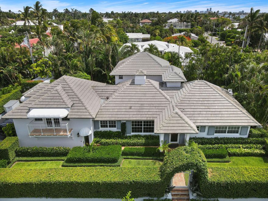 This gorgeous, completely updated North End home is nestled on a sprawling 11,900 sq ft corner lot on prestigious Osceola Way. This palatial home offers an open floor plan kitchen, 4 bedrooms, 4 bathrooms, and a free-standing, pool-side studio. The ground floor features a unique, exceptionally large loggia area surrounded by 5 sets of French Doors that lead to the pool area, tiled courtyard, fish pond, and studio with an orchid house. The second floor features two master bedroom suites, offering both spacious bathrooms and closets. While the first floor offers two bedrooms as well. The property is lushly landscaped with mature tropical plants, offering both quietness and privacy. Osceola Way offers a deeded beach and oceanfront cabana, exclusively available for Osceola Way residents.