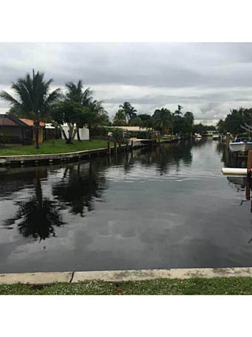 Unique water front home in Boulevard Park Isles.  3/2 with spacious 1 car garage with ample storage.  Large custom kitchen with granite counter tops.  Kitchen includes a two space desk area & other built in features. Beautiful Arched doorways & doors that  lead into the bedrooms with new stone flooring. Custom ceiling work.  Wood flooring in living room with a center stone medallion. Updated bathrooms with a custom design.  Home has a 9,079 sq. ft. lot. with mature trees and a view looking down the canal.