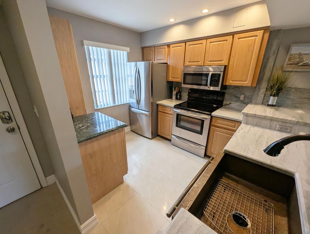 Photo of 1045 Lake Shore Drive #202, Lake Park, FL 33403 (MLS # B26024791)