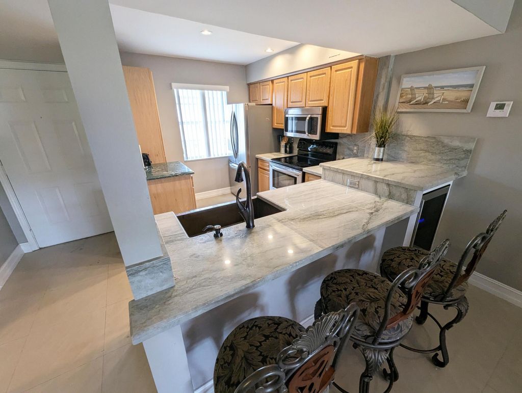 Photo of 1045 Lake Shore Drive #202, Lake Park, FL 33403 (MLS # B26024791)