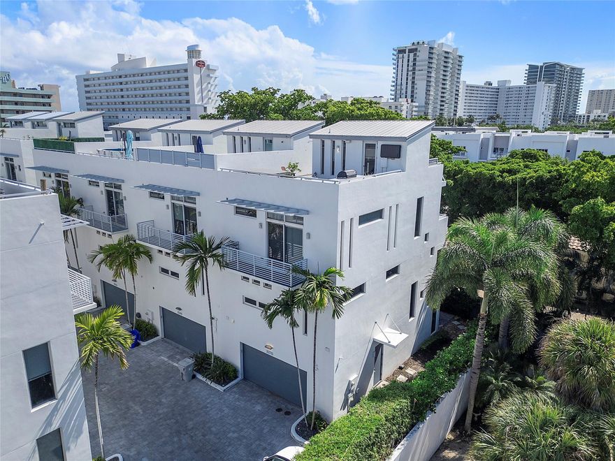 Totally updated 4-story townhome in Palm Cove Lofts featuring 3 bedrooms and 3.5 baths. Walking distance to the beach, water taxi and intracoastal. All impact windows and doors. The first level offers a private bedroom suite and elevator access to all floors. The second floor showcases a spacious living area and chef’s kitchen with 6 gas burners, large center island, abundant cabinets, double wine fridge, laundry room, and half bath. The third floor includes the luxurious primary suite with a walk-in closet, roman tub, and separate shower, plus an additional bedroom suite. Enjoy the rooftop oasis with a summer kitchen and hot tub perfect for entertaining or relaxing under the stars. Total upscale living in this private gated community.