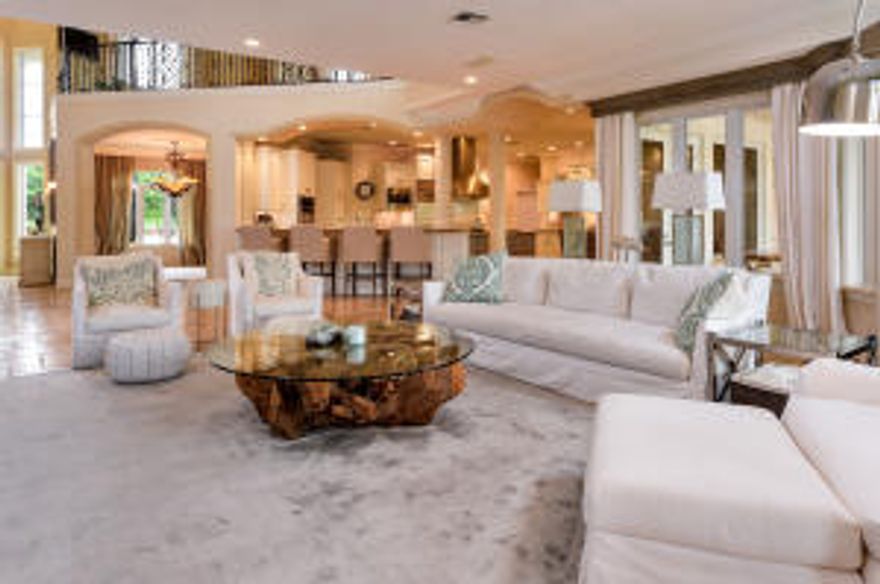 With a sophisticated blend of Mediterranean architecture and luxurious waterfront living, this gated two story estate appeals to the most discerning of clientele. Overlooking the intracoastal waterways, this exquisite home features 5 bedrooms, 6.5 baths, 3 car garage, a custom built office, gourmet kitchen with breakfast area and spacious outdoor living area with pool.Marble flooring throughout the first floor and the attention to detail sets the tone for exceptional entertaining.  With top of the line appliances, island cooktop, granite countertops and beautifully built cabinetry, the gourmet kitchen opens up to the breakfast area and living room. This spacious open floor plan is light and bright with French doors that open up