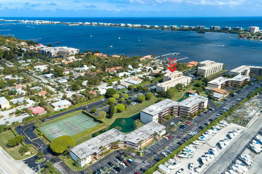 Fabulous southern views overlooking the pool and canal set the stage for this inviting condo in a gated intracoastal community. The kitchen features a raised ceiling with crown molding and updated appliances, creating a bright and open feel. Enjoy the convenience of an in-unit washer and dryer, along with accordion hurricane shutters for added peace of mind. This investor-friendly community allows rentals immediately after purchase and has no minimum credit score requirement, offering exceptional flexibility for owners and investors alike. Residents enjoy resort-style amenities including a clubhouse with exercise room, sauna, game room, and library, plus a community pool and tennis courts. Ideally located just minutes from pristine beaches, top-rated restaurants, and premier shopping.