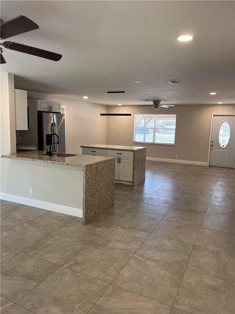 Updated 3/2 ready to to move in immediately located in central area with easy access to schools, restaurants, shops and healthcare facilities. There is no HOA review and approval can be done quickly. The kitchen has stainless steel appliances and double island with lots of space for seating and counter space for prepping or gathering. The split level bedrooms floor plan gives privacy and an very wide open space for family room, kitchen and dinning area. Big backyard with screen porched a large one car garage and three designated parking spaces.