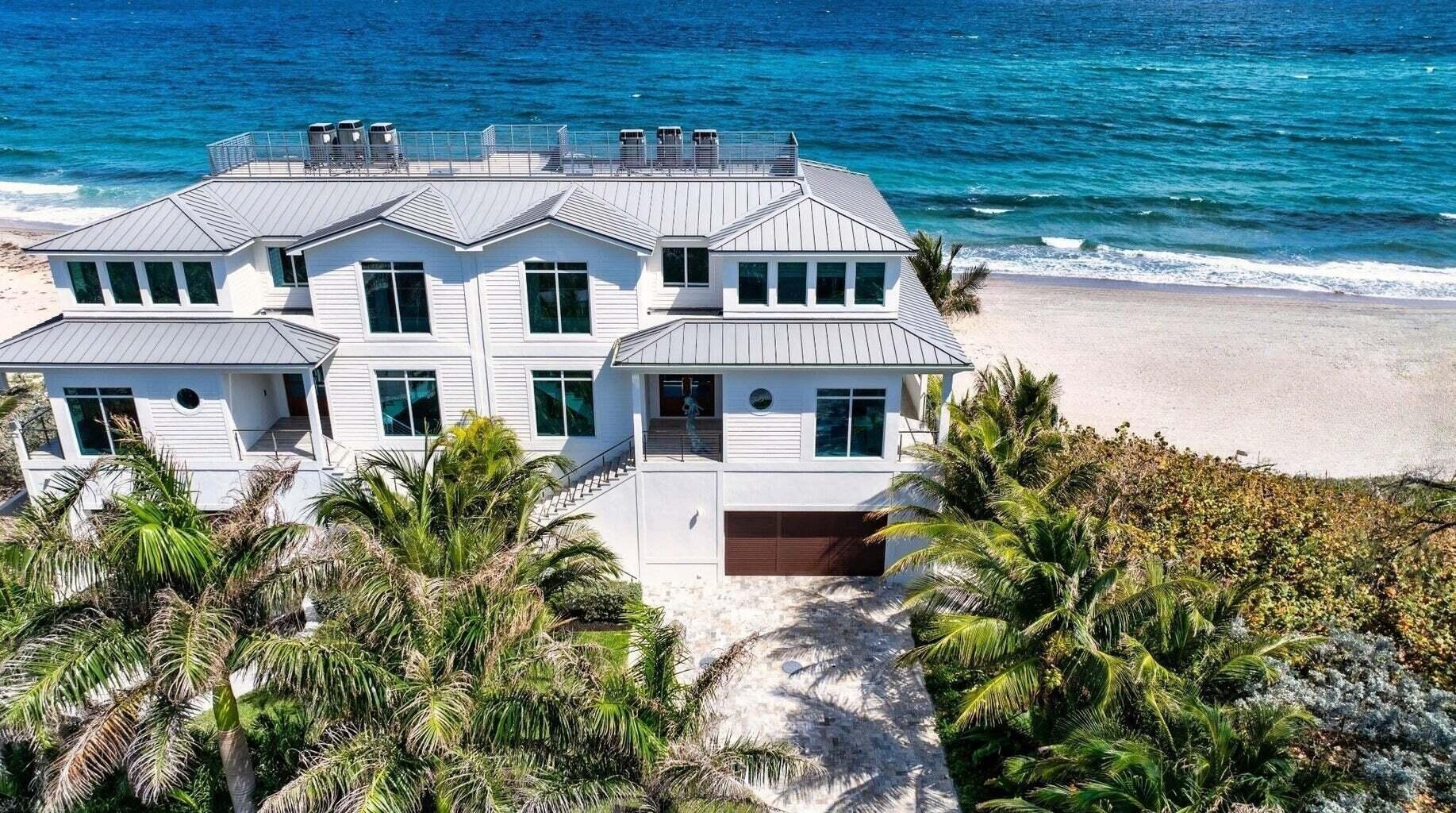 Ocean Ridge townhome, perched directly on the sand, showcases a sunny deck and an expansive wraparound balcony perfect for catching the sunrise. Designed with a sophisticated beach-chic flair, every room frames sweeping views of golden coastline and shimmering aquamarine waters. The main level boasts a light-filled open-concept living space. Downstairs rooms make ideal guest retreats, while the top-level primary suite, with its panoramic oceanfront perch, sits in the sunny southeast corner.