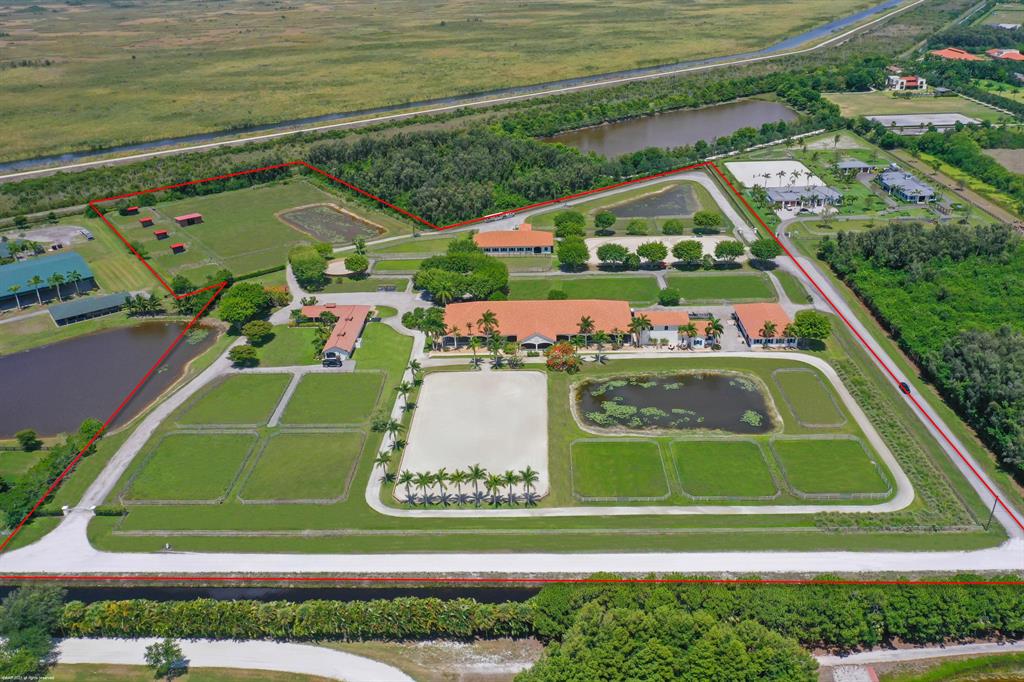 Private 20 Acre horse farm with 37 Stalls! This beautiful farm functions across all disciplines with 3 separate stables, 2 outdoor jumping arenas, covered riding arena with mirrors with viewing pavilion, 22 grass paddocks, 2 studio apartments, one 1Br/1Bth apartment & 3Br/1Bath owner's apartment, all peacefully nestled up against the everglades with an end of street location! The property also boasts: owner's lounge, air-conditioned feed rooms, 6 horse euro-walker, stallion paddocks, round pen, 3 RO systems, 80 KW Kohler diesel generator and 3 RV hookups. The back 5 acres is all pastureland with four 12' x 24' run-in sheds & 4 stall ctr-aisle pole barn with water & electric, all of which are bonus stalls in addition to the 37 stalls in the show barns!