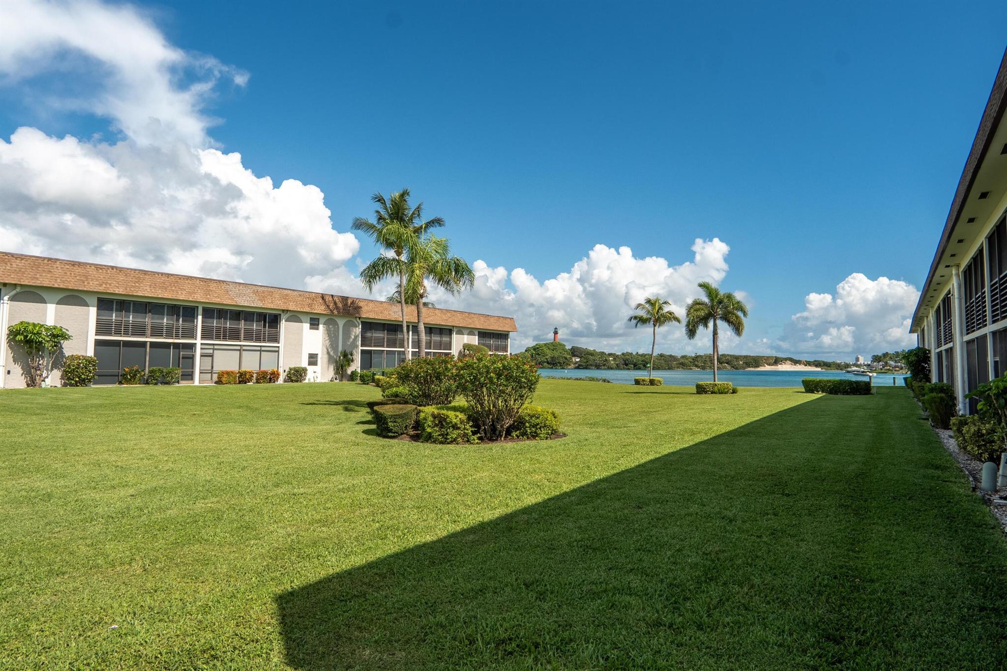 Luxury Waterfront 2026 Seasonal Rental - 55+ Active Community | Prime Jupiter Inlet Location. Experience the best of coastal living in this beautifully renovated 2BR, 2BA condo, perfectly situated on the second floor with lovely views of the turquoise waters of Jupiter Inlet and the iconic Jupiter Lighthouse from the expansive enclosed lanai, complete with a large family dining table, ideal for al fresco meals while enjoying the peaceful view. This fully furnished luxury rental features seamless tile flooring throughout, a tastefully updated kitchen with modern finishes, and elegant bathrooms. The primary suite offers private access to the lanai, a spacious walk-in closet, and an ensuite bathroom with a jetted soaking tub. This condo is your turnkey retreat in paradise!