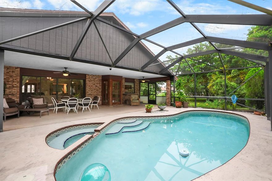 Discover this 3-bedroom, 3-bath pool home on a coveted corner lot in desirable non-HOA Floresta Gardens. Boasting 2,252 sq ft of living space, this home features a charming brick exterior and a spacious split-floorplan with a rare cabana bath, large bedrooms, and upgraded oversized tile flooring - no carpet! Perfect for entertaining, you'll love the wet bar, kitchen pass-through to the patio, and expansive outdoor living area with a covered patio and screen enclosure. Additional highlights include gutters, a newer water heater & refrigerator, and a layout designed for privacy and comfort. All this in a prime location, just 15 minutes from the shops and restaurants of Tradition and St Lucie West. This well-cared-for, one-owner home blends indoor elegance with outdoor enjoyment.