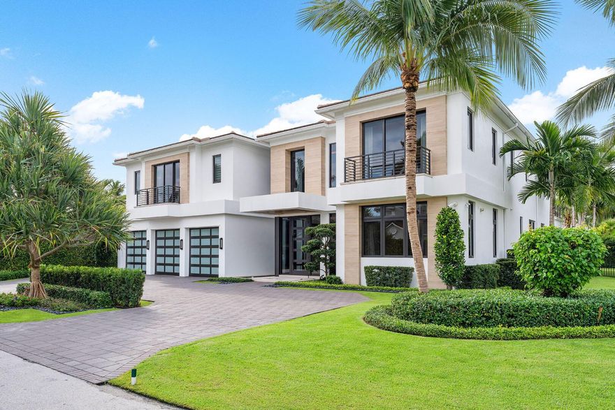 254 Fern Palm Road is an exceptional 5-bedroom Signature Estate built by renowned SRD Building Corp, offering 6,635 sf of contemporary, natural glam living on a corner interior lot in the Royal Palm Yacht & Country Club. An in-ground fountain styles the modern entry to a grand foyer, bathed in natural light via a glass-paneled entry door and double-height windows. European white oak floors flow throughout. Exquisite details include the stunning, dual-tone custom kitchen cabinetry, a large porcelain kitchen island, an equipped wet bar, a temperature-controlled wine room, fully collapsing sliding glass doors, Crestron smart home tech, and a full security system.