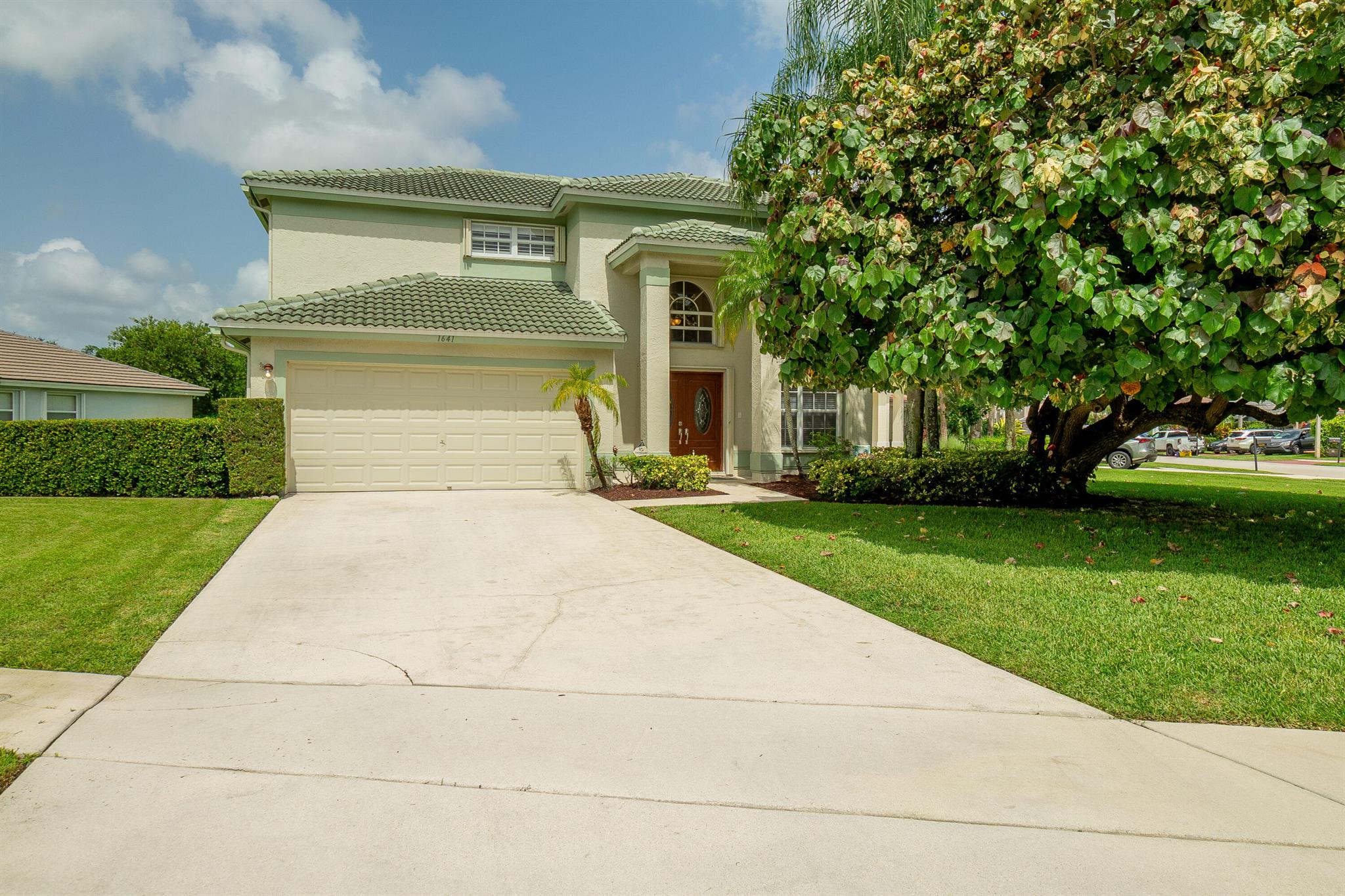 Welcome to this fantastic 4 bedroom 2.5 bathroom pool home situated on a premium corner lot with fantastic lake views! Well maintained large yard with beautiful pool, oversized pool deck, covered screened patio, lush landscaping and fenced for privacy. Property has newer roof (2022), accordion hurricane shutters for quick and easy storm protection, newer kitchen appliances and quartz countertop, newer paint inside and out, window and sliding door plantation shutters, tile and luxury vinyl flooring throughout, no carpet! Master bedroom has a covered balcony for extra outdoor space and beautiful view of the lake. Lakefield North is a well maintained gated community zoned for good schools and just a golf cart ride away to equestrian activities, polo and several private golf courses.