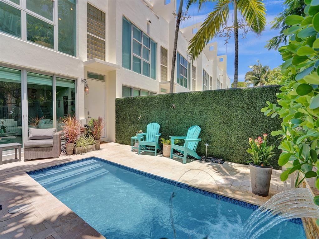 Stunning 3-story townhome with private pool in Victoria Park’s boutique community. This contemporary residence features open floor plan filled with natural light, highlighted by an atrium-style living room with soaring ceilings. The gourmet European kitchen offers Poggenpohl cabinets, granite countertops, stainless steel appliances, and a center island. Two primary suites each include walk-in closets, spa-like baths with Whirlpool tubs, stand-alone showers, double vanities & private balconies. The 2-car garage has epoxy flooring and built-ins, while the redesigned courtyard boasts new pavers surround the private pool with lush greenery & a waterfall. Just minutes from the beach, Las Olas, shopping, dining, and the airport, this home offers luxury living at its finest.