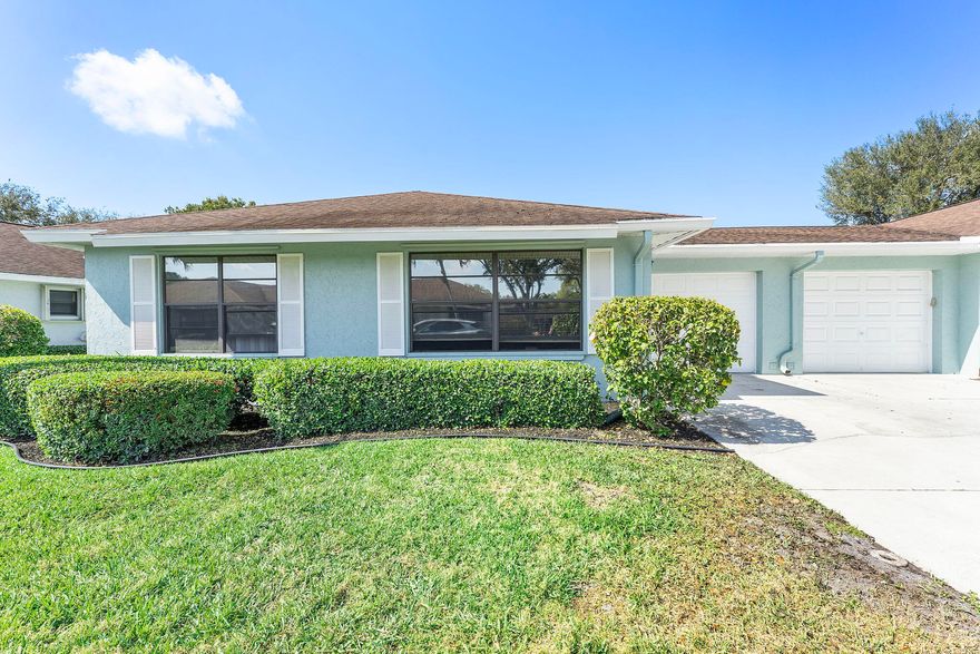Welcome home to Bent Tree East, this quiet Villa community is nestled in the heart of Boynton Beach. This villa comes complete with a new roof by June of 2026, no assessment. New Vinly flooring as you enter along with all fresh paint inside the home. Attached one car garage that offers extra storage in the attic along with washer and dryer inside. Kitchen offers a large pantry and slider to your screened in patio. Large Master bedroom has 3 closets including one as a walk-in and separate bathroom. Guest bathroom has a walk-in shower with new tile.  Hurricane protection with 100% panels.  AC is 11/2021. HOA covers landscaping, pest control, water, sewer and trash, pool, cable and internet and COMPLETE roof coverage.