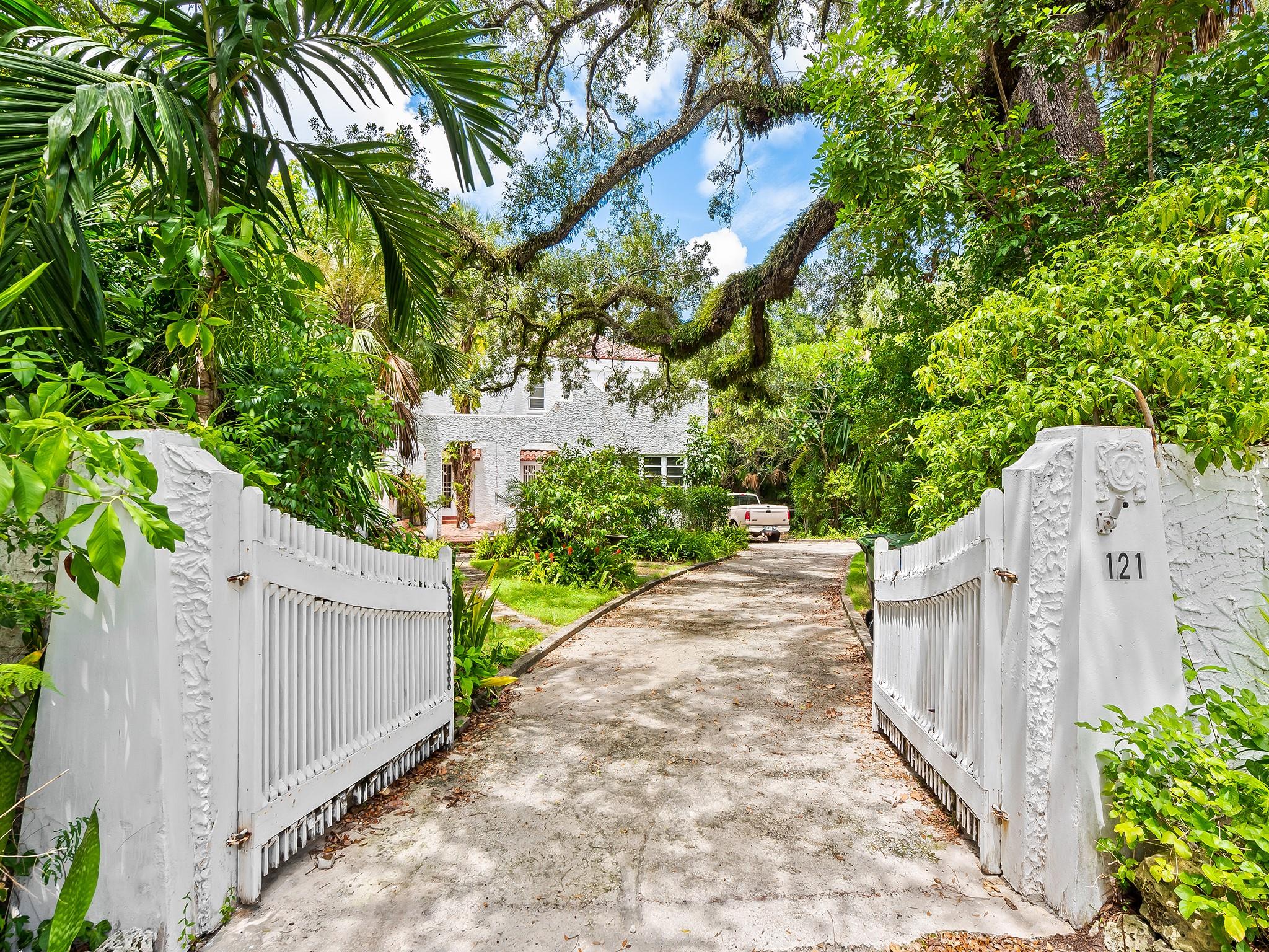 Tucked away on Rose Drive, this ultra-private 37,406 SF magical gated compound offers 207’ WF on the Historical Tarpon River & is zoned ROA|Residential, allowing for flexible residential and/or limited office use. Elevated at 12’ & located in a non-flood zone, the property includes a 3bed|2bath main residence with vintage charm, a walk-in basement, a detached garage, & a separate 1bed|1bath guest house. The interior has been completely demoed, providing a rare opportunity to design or build entirely to your vision. Whether you’re looking to create a truly magical private estate home, a unique business space, or a combination of both, this secluded retreat is a blank canvas with limitless potential. Mature foliage! The property can also be subdivided into two parcels. Sold As Is.