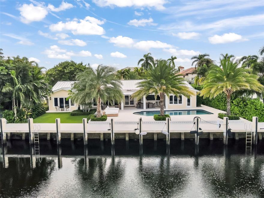 Welcome to your coastal retreat, where luxury meets exceptional craftsmanship. Boasting 100’ of unobstructed water frontage & stunning views of intertwining canals at anytime of the day. This meticulously updated home feats. PVC plumbing, metal roof, new electrical panels w. complete rewiring, tankless water heaters & a whole-home generator. Added feats. include wet bar w. 2 subzero wine fridges & ice maker, climate-controlled garage, outdoor kitchen, patio w. privacy drop screens & full impact windows/doors w. newly installed ballistic hurricane covers.  Boaters enjoy newly raised seawall, dock & no fixed bridges - only 7 mins to ocean access. If you’ve been waiting for a truly turnkey home in a premier neighborhood with seamless design for an indoor-outdoor living experience, this is it!