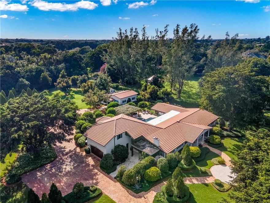 Elegant Mediterranean exterior ties in historic European Architecture with timeless style and charm. Expansive 3.67 acres of manicured & lighted landscape with pool, jacuzzi & hurricane rated pergola make this estate an entertaining paradise. 2 bedroom guest house boasts new Roof, Impact windows & upgraded electrical. Main House features West wing dedicated to 3 bedrooms, bath & a second master ensuite for maid/Nanny. East wing hosts the Master with attached sitting room/gym & Private stairs to dual office w/wet bar & patio. Ample room for entertaining with formal living, dining rooms & family room with fireplace off the eat in kitchen. Chef's dream kitchen w/Viking appliances, 2 Sub Zero refrigerators & 3 ovens. Complete house generator, Exquisite neighborhood, A+ Schools & much more!