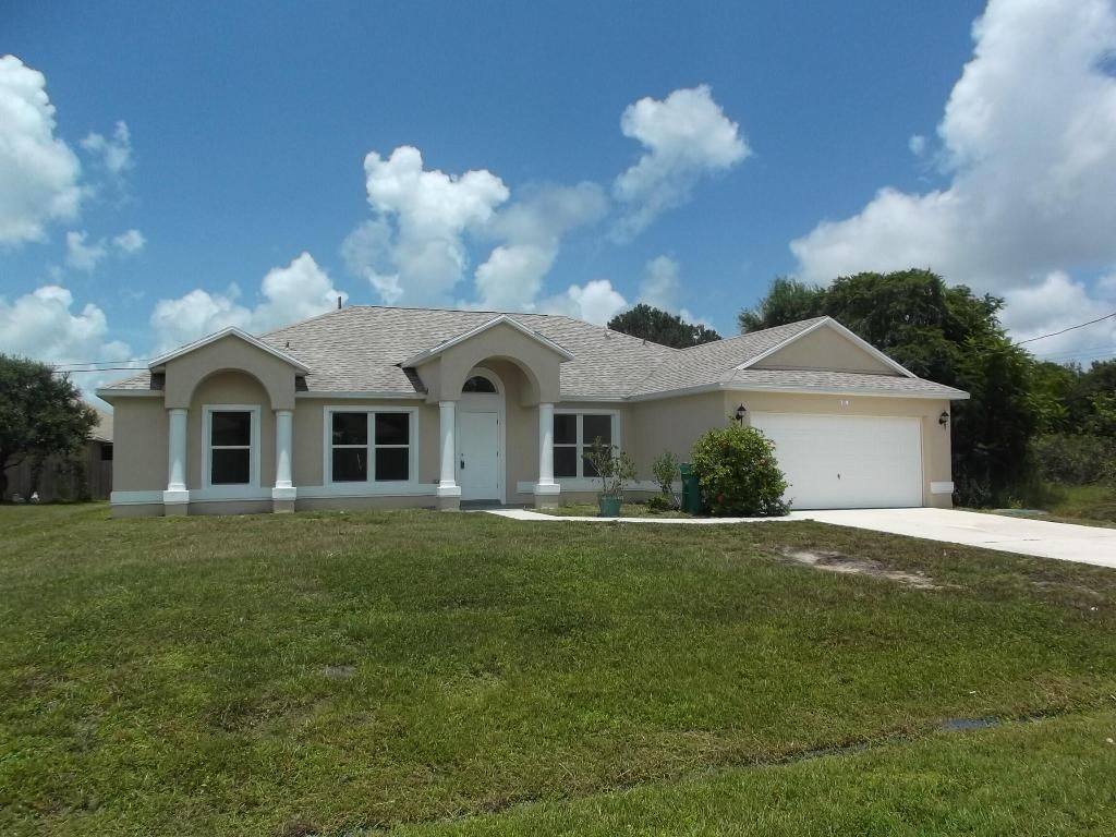 Photo of 319 SW Fig Avenue, Port Saint Lucie, FL 34953 (MLS # R10949788)